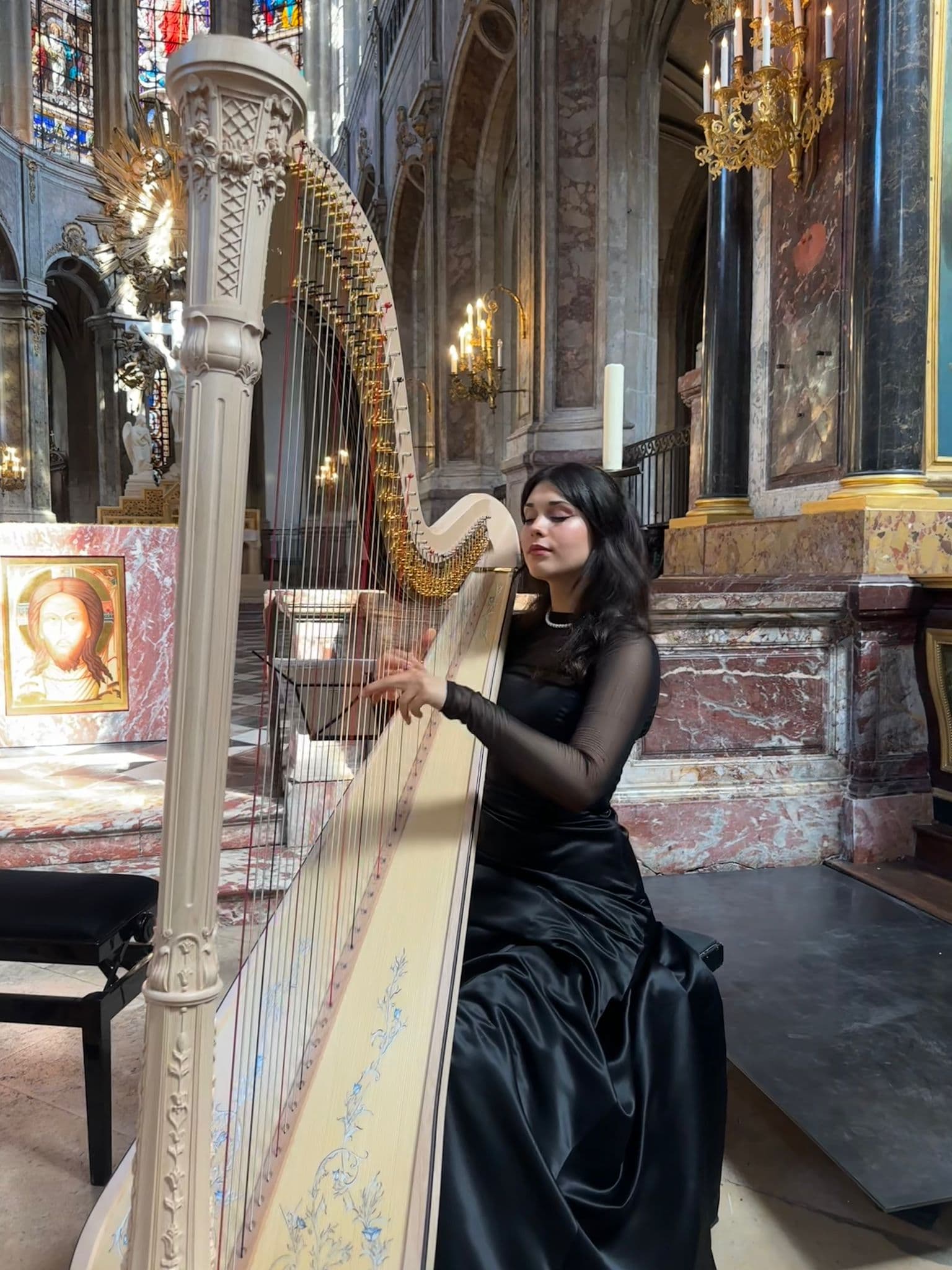 Alexandrina playing harp in a church