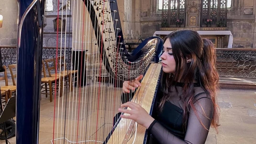 Alexandrina performing on harp
